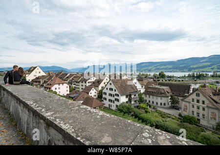 Rapperswil, SG / Switzerland - 3. August 2019:  summertime teenager romance on the castle walls above the old town of Rapperswil Stock Photo