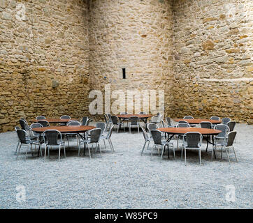 Rapperswil, SG / Switzerland - 3. August 2019:  castle courtyard with defense walls and table and chair seating for a dinner party Stock Photo