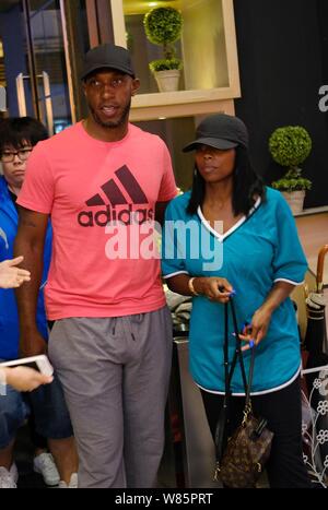 Retired NBA star Chauncey Billups, left, and his wife are pictured at a concert of Chinese girl group SNH48 in Shanghai, China, 7 September 2016. Stock Photo