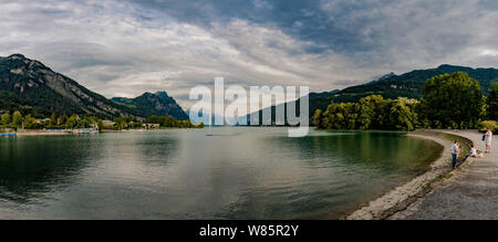 Weesen, SG / Switzerland - 3. August 2019: panorama view Walensee Lake and Weesen Harbor in summer with visiting tourists and a view Stock Photo