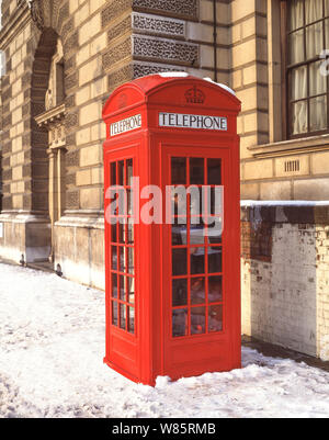 Traditional red telephone kiosk in winter snow, Parliament Square, City of Westminster, Greater London, England, United Kingdom Stock Photo
