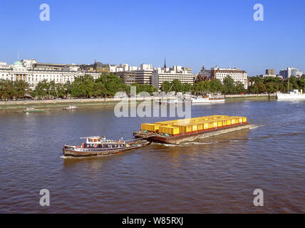 Tugboat towing floating container barge on River Thames, South Bank, London Borough of Lambeth, Greater London, England, United Kingdom Stock Photo