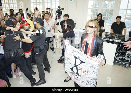 Singer and composer Yoshiki Hayashi, right, better known by his stage name Yoshiki, of Japanese heavy metal band X Japan, attends a promotional event Stock Photo