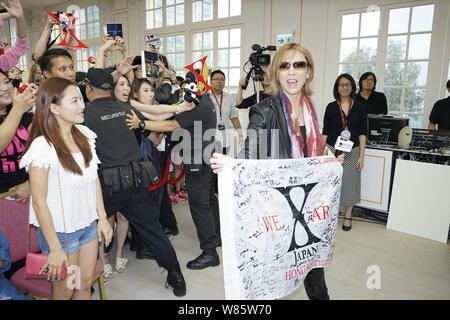 Singer and composer Yoshiki Hayashi, right, better known by his stage name Yoshiki, of Japanese heavy metal band X Japan, attends a promotional event Stock Photo