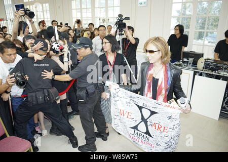 Singer and composer Yoshiki Hayashi, right, better known by his stage name Yoshiki, of Japanese heavy metal band X Japan, attends a promotional event Stock Photo