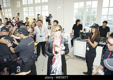 Singer and composer Yoshiki Hayashi, center, better known by his stage name Yoshiki, of Japanese heavy metal band X Japan, attends a promotional event Stock Photo