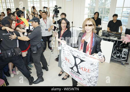 Singer and composer Yoshiki Hayashi, right, better known by his stage name Yoshiki, of Japanese heavy metal band X Japan, attends a promotional event Stock Photo