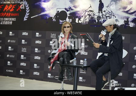 Singer and composer Yoshiki Hayashi, left, better known by his stage name Yoshiki, of Japanese heavy metal band X Japan, attends a promotional event f Stock Photo