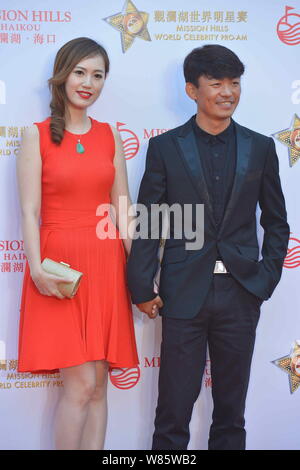 --FILE--Chinese actor Wang Baoqiang, right, and his wife Ma Rong pose as they arrive on the red carpet for the Mission Hills World Celebrity Pro-Am in Stock Photo