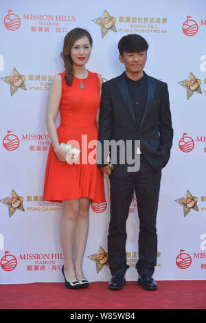 --FILE--Chinese actor Wang Baoqiang, right, and his wife Ma Rong pose as they arrive on the red carpet for the Mission Hills World Celebrity Pro-Am in Stock Photo