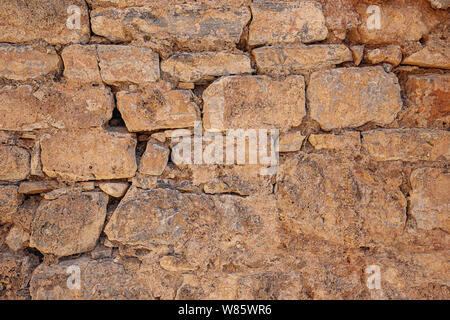 Old grungy stone wall texture in brown tone Stock Photo