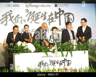 Chinese actress Zhou Xun, second left, and director Lu Chuan, right, attend the premiere of the nature documentary 'Born in China' in Beijing, China, Stock Photo