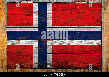 National flag of Norway on a wooden wall background.The concept of national pride and symbol of the country.Flag painted on a wooden fence with metal Stock Photo