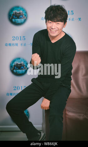 --FILE--Chinese actor Wang Baoqiang poses during an interview to promote his movie 'Impossible' in Beijing, China, 28 November 2015.   Dropping a bomb Stock Photo