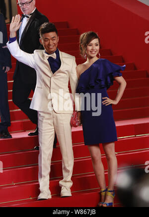 --FILE--Chinese actor Wang Baoqiang, left, and his wife Ma Rong pose as they arrive on the red carpet for a premiere event of his movie 'A Touch of Si Stock Photo