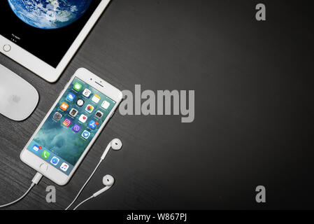 Kyiv, Ukraine - Fabruary 6, 2018: Apple iPhone 8 plus with ipad and computer mouse on black table, top view. Apple Inc. is an American multinational c Stock Photo
