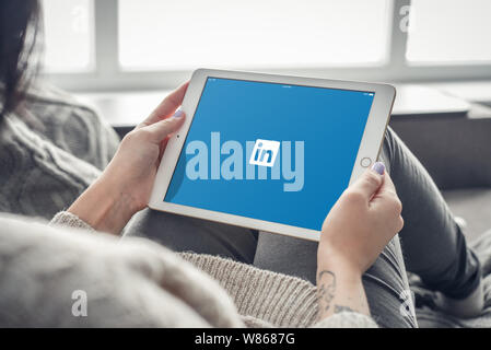 Kiev, Ukrain - February 10, 2018: Woman using Linkedin app on a brand new Apple iPad Pro Silver, 7th generation of the iPad, developed by Apple inc. a Stock Photo