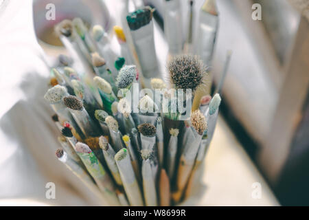 close up top view pack of watercolor painting hair  brushes in basket, copy space Stock Photo