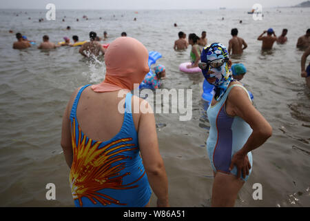 Chinese women wearing facekinis are pictured at a beach resort in