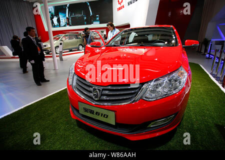 --FILE--Visitors look at a Baojun 610 of SGMW (SAIC-GM-WULING) on display during the 13th Beijing International Automotive Exhibition, also known as A Stock Photo