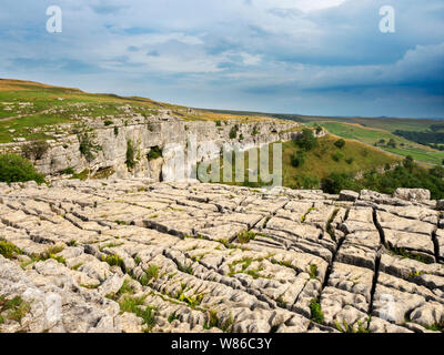 Limestone pavement and cliffs from the top of Malham Cover near Malham Yorkshire Dales National Park England Stock Photo