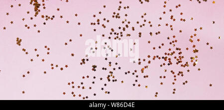 Festive backdrop with golden star shaped confetti Stock Photo