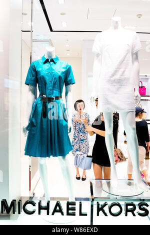 --FILE--Customers are shopping in a fashion boutique of Michael Kors (MK) at the Taikoo Li Sanlitun shopping center in Beijing, China, 28 May 2015.  A Stock Photo