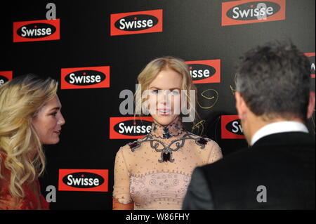 Australian actress Nicole Kidman, center, and model Ashley Hart, left, arrive for a promotional event by Australian healthcare brand Swisse in Shangha Stock Photo