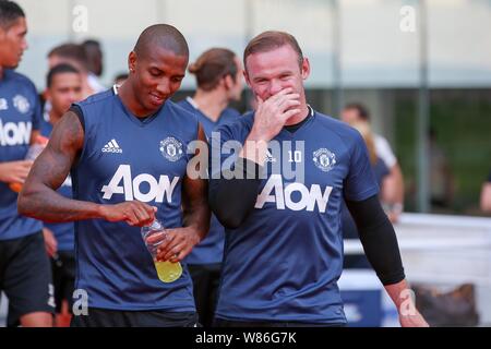 Wayne Rooney, right, of Manchester United talks to Ashley Young as they arrive for a training session for the Shanghai match of the 2016 International Stock Photo