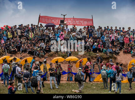 Visitors and people of Yi ethnical minority gather to celebrate the Torch Festival in Butuo county, Liangshan Yi autonomous prefecture, southwest Chin Stock Photo