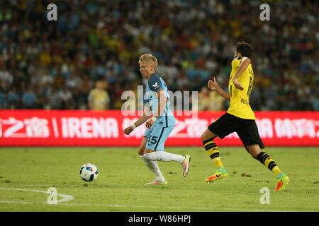 Alex Zinchenko of Manchester City, left, challenges Samir Nasri of Borussia Dortmund during the Shenzhen match of the 2016 International Champions Cup Stock Photo