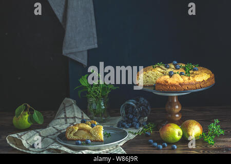 Delicious dessert blueberry tart with fresh berries and pears, sweet tasty cheesecake, berry pie. French cuisine Artistic Still Life in the style of D Stock Photo