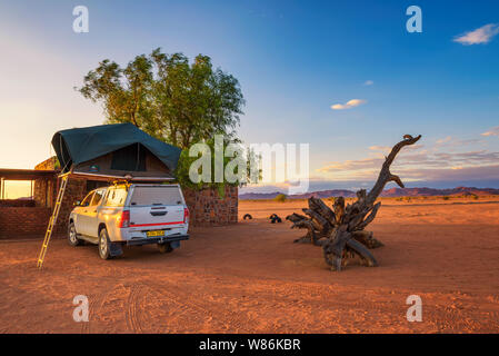 Tent located on the roof of a pickup 4x4 car in a desert camp, Namibia Stock Photo