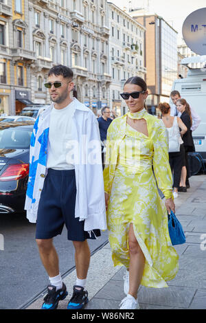 MILAN - JUNE 16: Woman with white and blue Louis Vuitton sneakers walking  before Marni fashion show, Milan Fashion Week street style on June 16, 2018  Stock Photo - Alamy