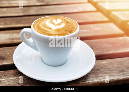 Fresh cappuchino or flat white coffee in a white cup with latte art on it close-up Stock Photo