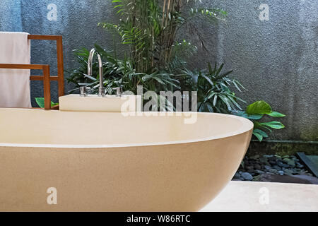 Stone bathtub in modern villa with open space bathroom. Luxury interior Stock Photo