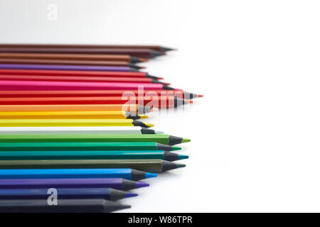 Colorful background or banner with place for text, copy-space. Color pencils on the left on a white background. Mockup Stock Photo