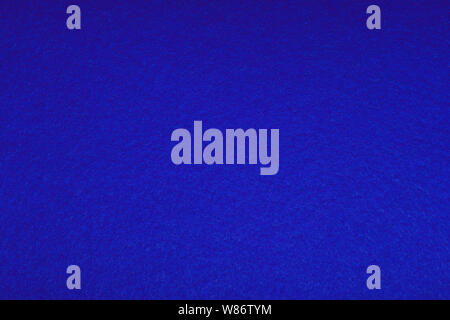Brightly blue colored felt - background, soft fluffy texture, tissue. Abstract art background. Colored construction paper surface. Empty space. Stock Photo