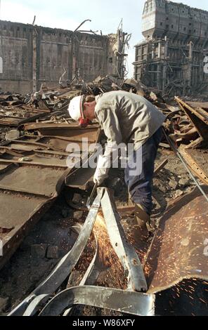 01 January 1992, Berlin, Lauchhammer: Federal States / Brandenburg / GDR / Industry 1992 End of the GDR. The large coking plant Lauchhammer is torn down. That's where they made coke out of brown coal. The photo symbolizes the dismantling of the GDR economy, environmental damage is being repaired, tar residues and all conceivable olefine pollutants must be removed. // Treuhand / Demolition / Economy / Environment During the Cold War, the GDR could not get coke for its steelworks from the West. She had to make it from lignite. The coking plant was supplied by 7 open pit lignite mines. After the Stock Photo