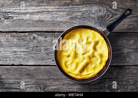 classic omelet, a dish of beaten eggs cooked in a skillet, view from above, flatlay, copy space Stock Photo