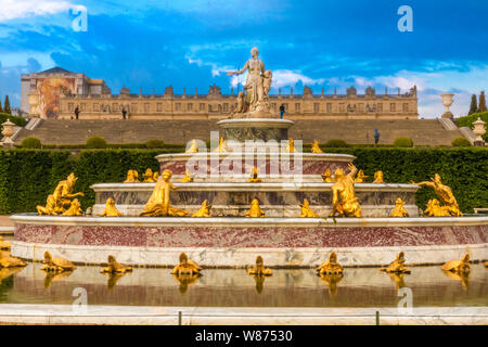 Great close-up view of the Latona Fountain (Bassin de Latone) in the Gardens of Versailles with the Chateau in the background. On the top tier is a... Stock Photo