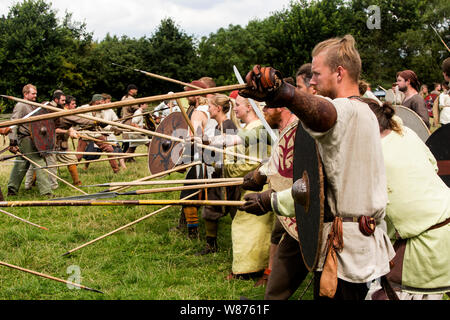 Viking warriors are fighting on the battlefield at Ribe Viking Centre in Lostrupholm near Ribe, Denmark. Some 200 warriors, both men and women, participate in the dramatic and true to life battle which is fought with contemporary weapon and is based on the Nordic 9th century Regnar Lodborg viking saga. Ribe Viking Centre is an experience centre situated near the historical Viking town, Ribe, on the southern part of the Danish mainland. Stock Photo