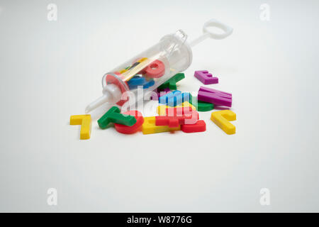 a collection of letters all jumbled up as if squirted from a syringe. symbolic of dyslexia, learning difficulties, language problems, misunderstanding Stock Photo
