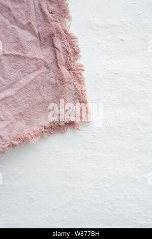 Avocado dyed material on white wall Stock Photo