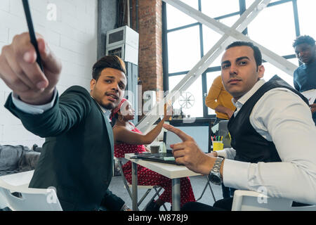 Designers architects discuss the action plan at the meeting. International negotiations of business partners Stock Photo