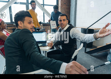 Designers architects discuss the action plan at the meeting. International negotiations of business partners Stock Photo
