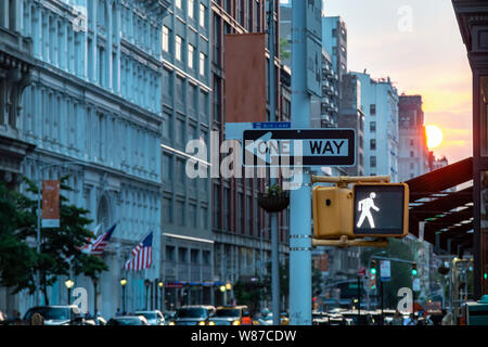 One way street sign on 5th Avenue in Midtown Manhattan New York City with the colorful light of sunset in the background Stock Photo