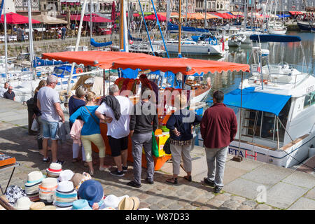 A market stall by the harbour at the Saturday market in Honfleur, Normandy, France Stock Photo