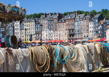 Fishing nets dry in the sun by the old harbour in Honfleur, Normandy, France Stock Photo