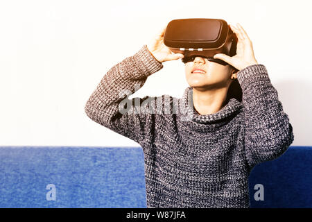 woman wearing virtual reality glasses. Smartphone using with VR headset Stock Photo